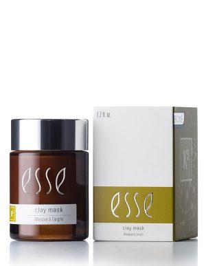 An Esse Clay Mask in a brown jar with a black lid is placed beside its box packaging. Both the jar label and the box display the Esse logo and product name. The primarily white box has a green section, and the clay mask is labeled as 1.7 fl. oz.