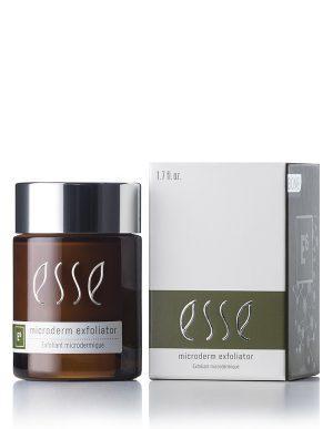 A brown jar of Esse Microderm Exfoliator with a black lid stands next to its packaging box. The white and green box highlights the product name and volume, 1.7 fl. oz., showcasing eco-friendly branding with an elegant, clean design.