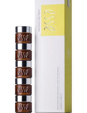 Stack of five small brown jars with silver lids labeled "esse" next to a tall rectangular box with "Esse Omega Rich Moisturiser" printed on it. The box has a white and yellow design and indicates it contains 5 jars (5x10ml/0.33 fl oz).